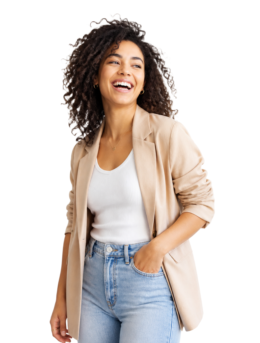 A young professional laughing, standing in bright daylight.